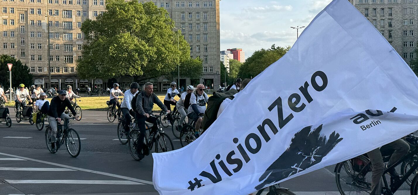 Ride of Silence 2025 weiße Vision Zero Fahne weht vor Radfahrenden
