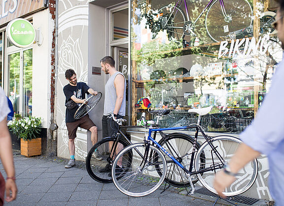 zwei Männer vor einem Fahrradladen