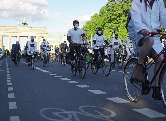 weiß gekleidete Radfahrende beim Ride of Silence vor dem Brandenburger Tor